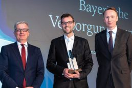 Kees-Jan van de Kamp von NN Investment Partners (r.) überreichte den Award an Andreas Hallermeier, vom ­Juryvorsitzenden Rolf Häßler (l.) kam die Begründung für die Auszeichnung. (Bild: Andreas Schwarz)